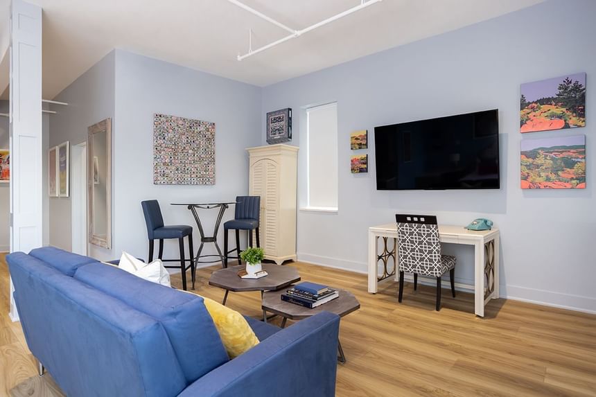 TV lounge area with cozy sofa & working table in King Premiere at Retro Suites Hotel