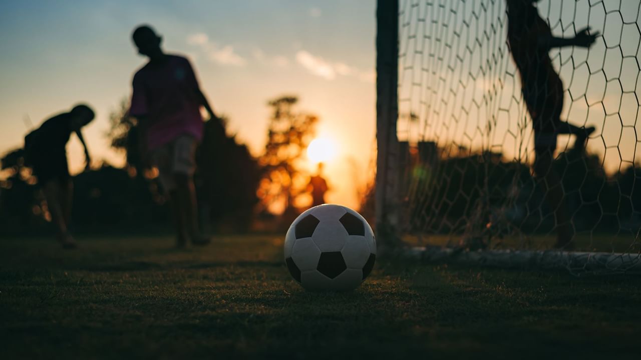 Kids playing soccer at dusk near Coast Hinton Hotel
