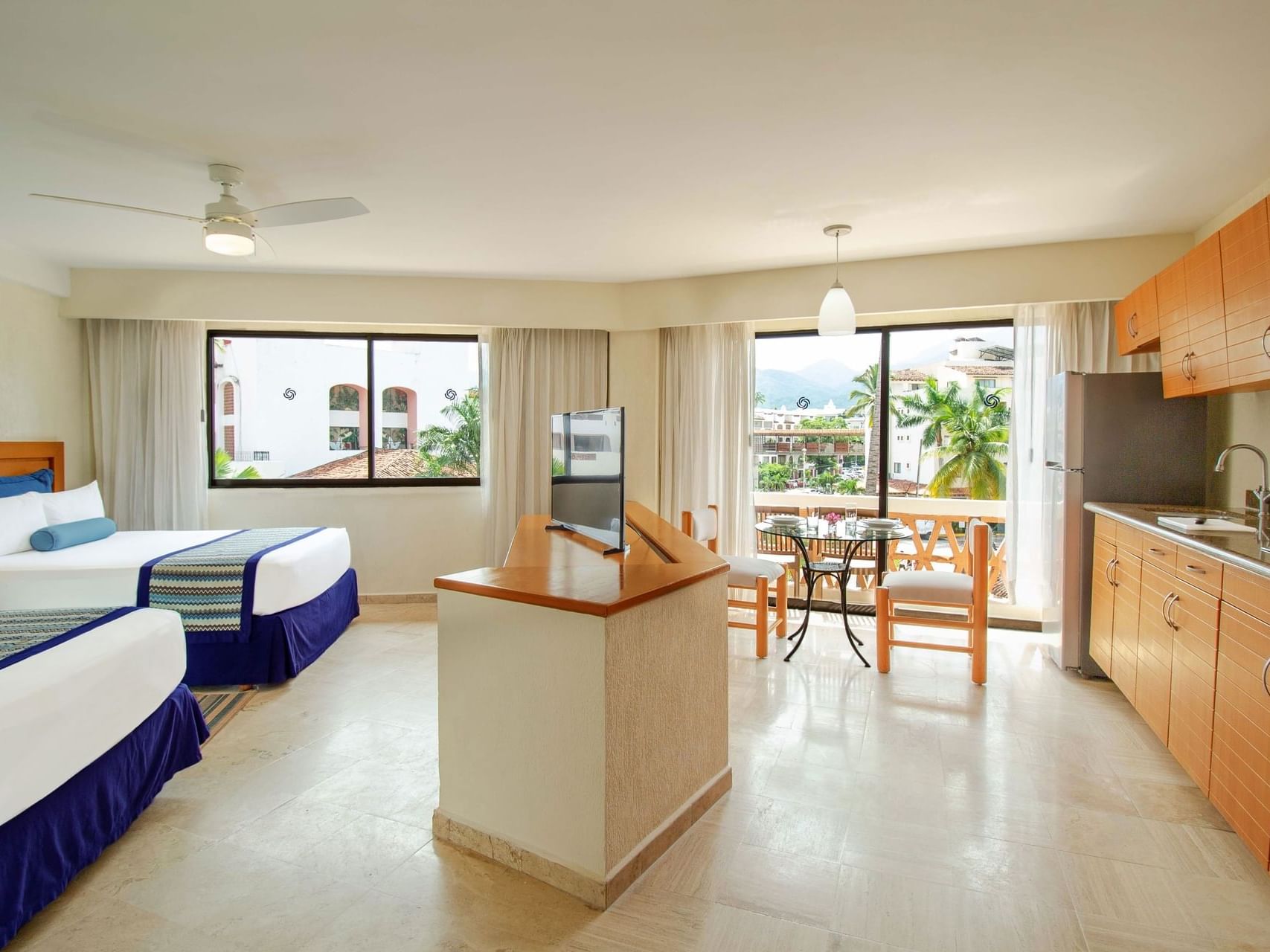 Pantry & dining table by the beds in Studio with Kitchen at Plaza Pelicanos Grand Beach Resort