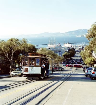 San Francisco city with cable cars running on F-line and vehicles on the road near Becks Motor Lodge