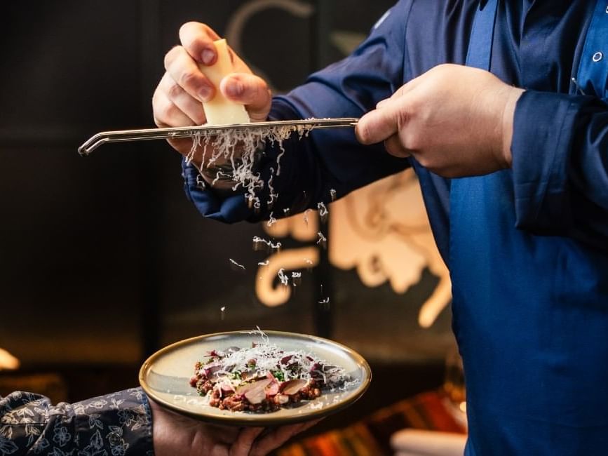 Grating cheese on top of a dish