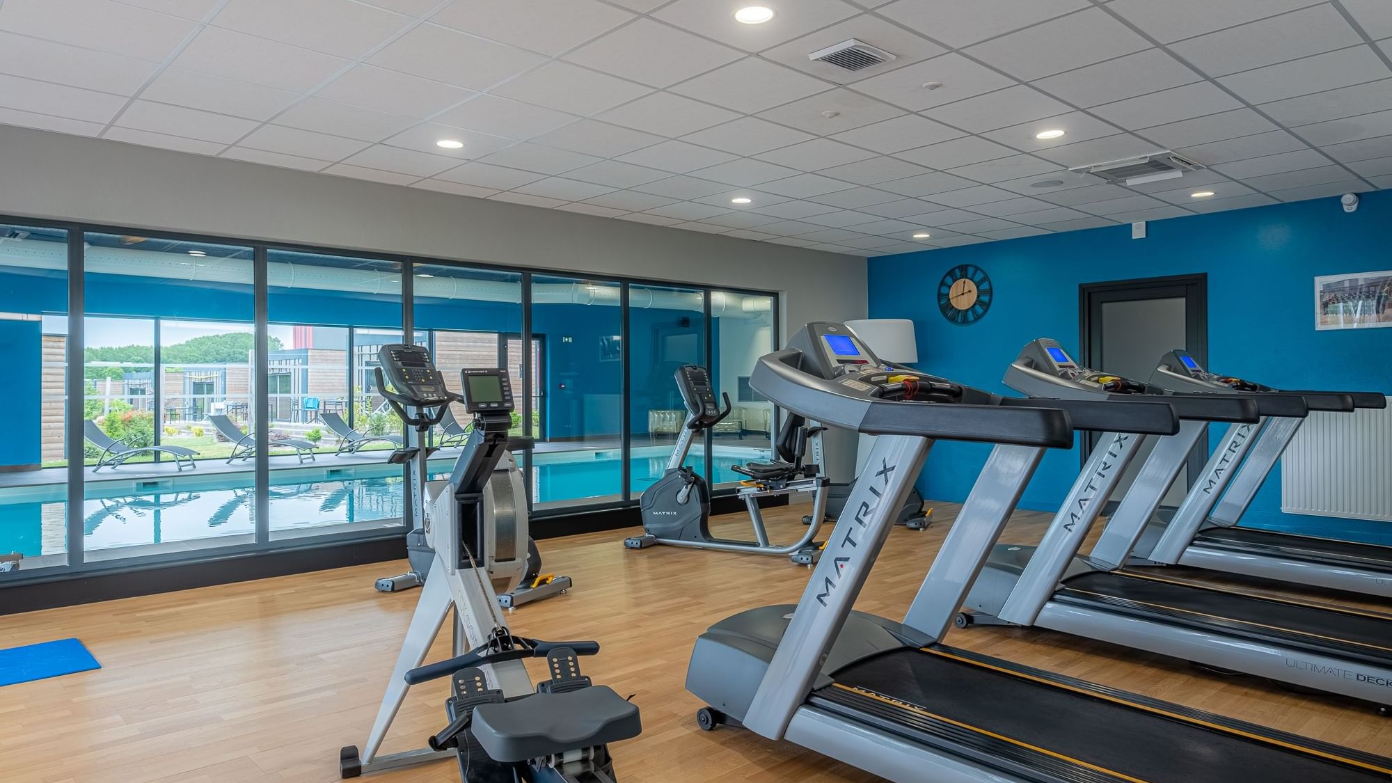 Gym with exercise machines at The Originals Hotels