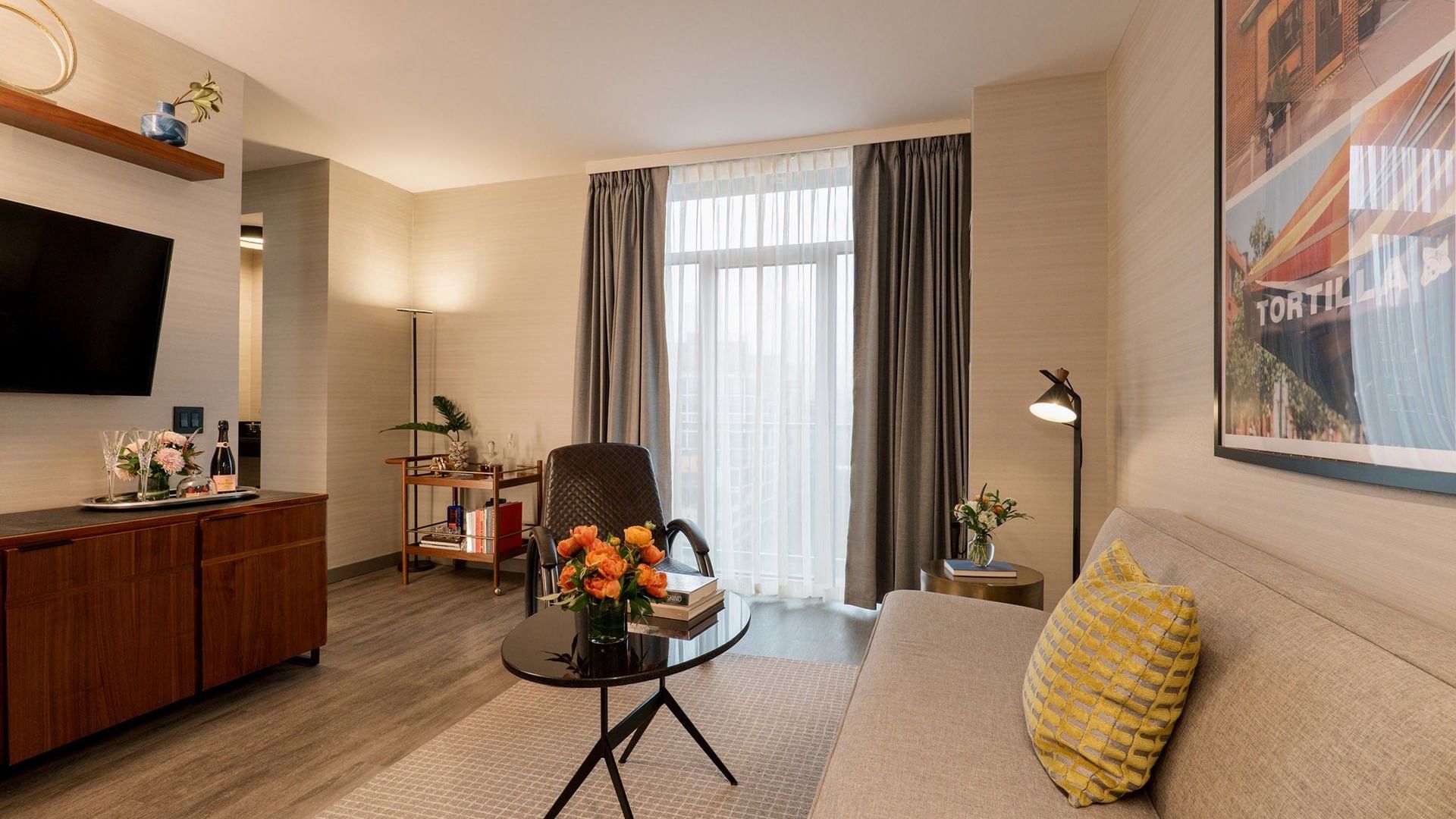 Spacious Gansevoort Suite living area with modern furnishings and city views at Gansevoort Meatpacking NYC - NEW