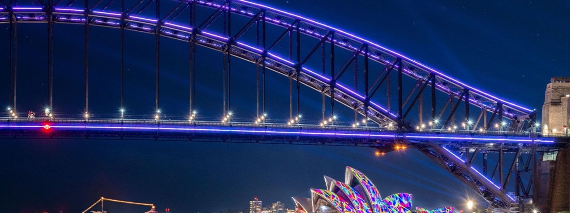 Illuminated Sydney Harbour Bridge and Opera House at night during Vivid Sydney.