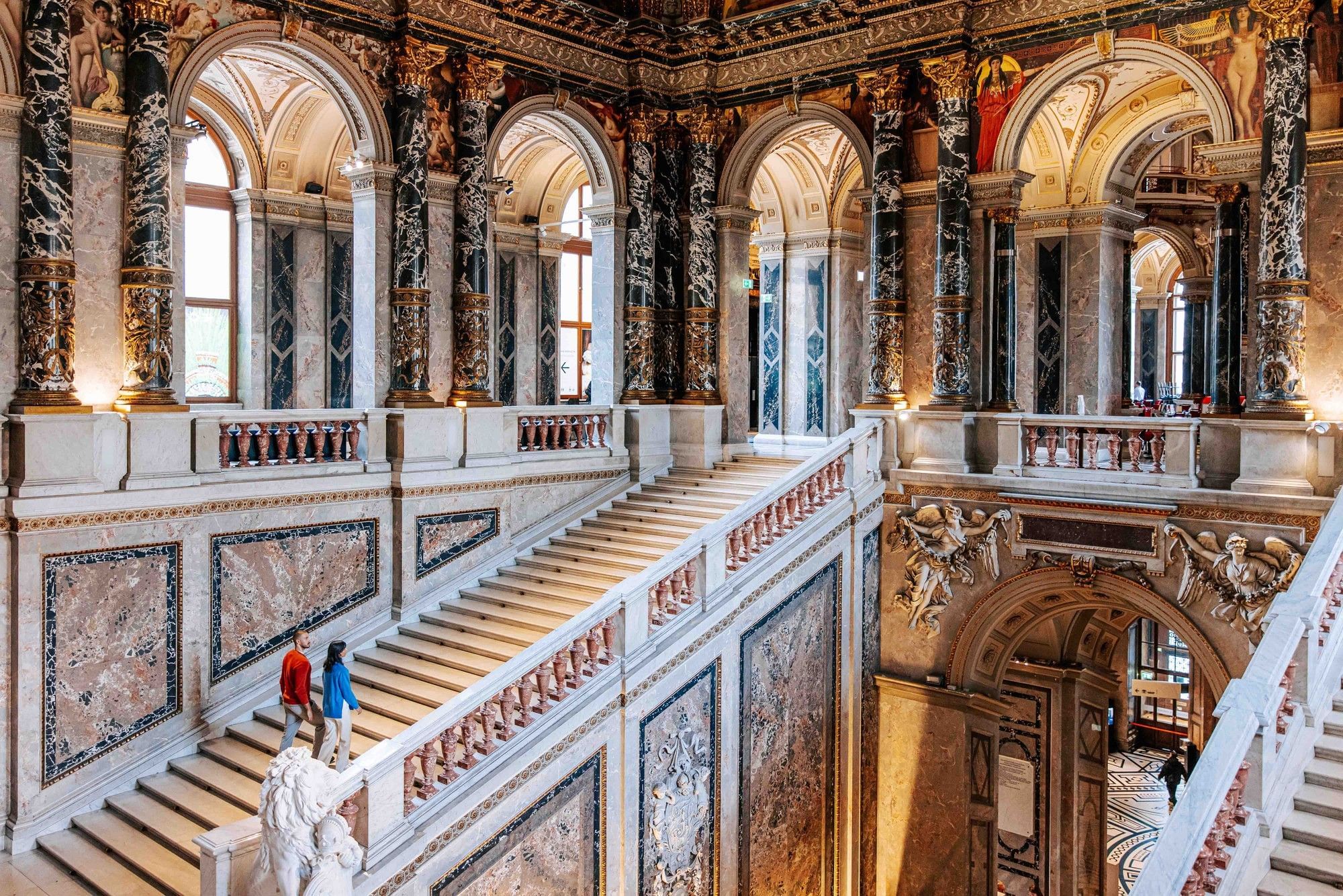 Magnificent staircase at the Kunsthistorisches Museum Vienna with marble columns, wall paintings and historic architecture