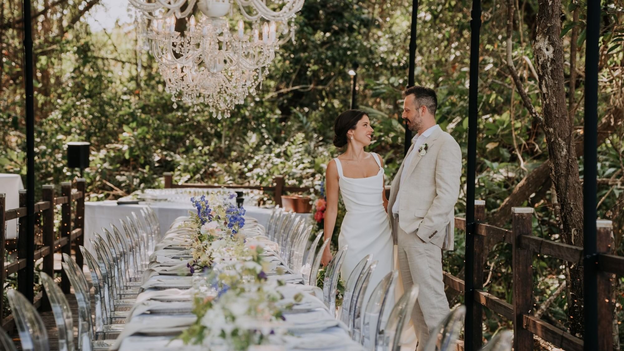Couple standing by table set-up & chairs in  Four Mile Beach at Pullman Port Douglas