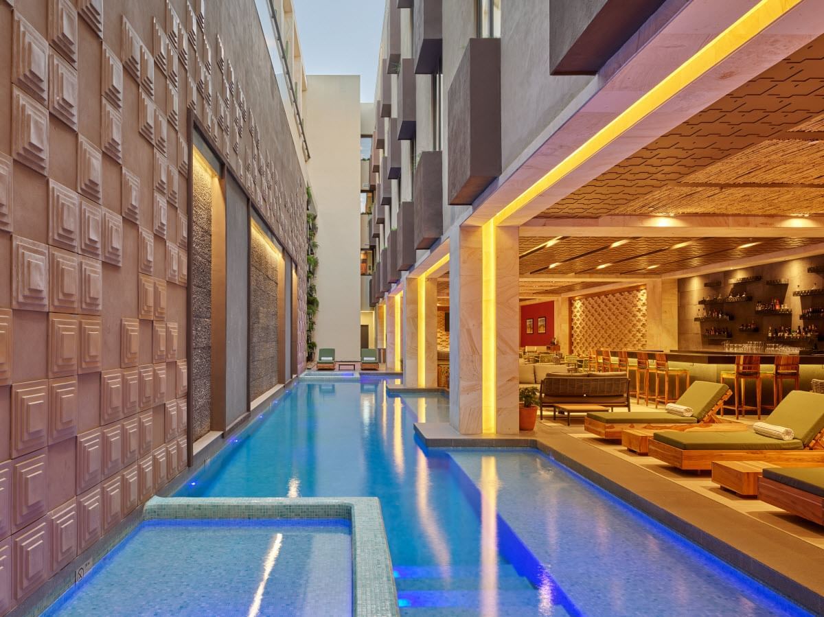 Outdoor pool area with pool beds at Grand Fiesta Americana