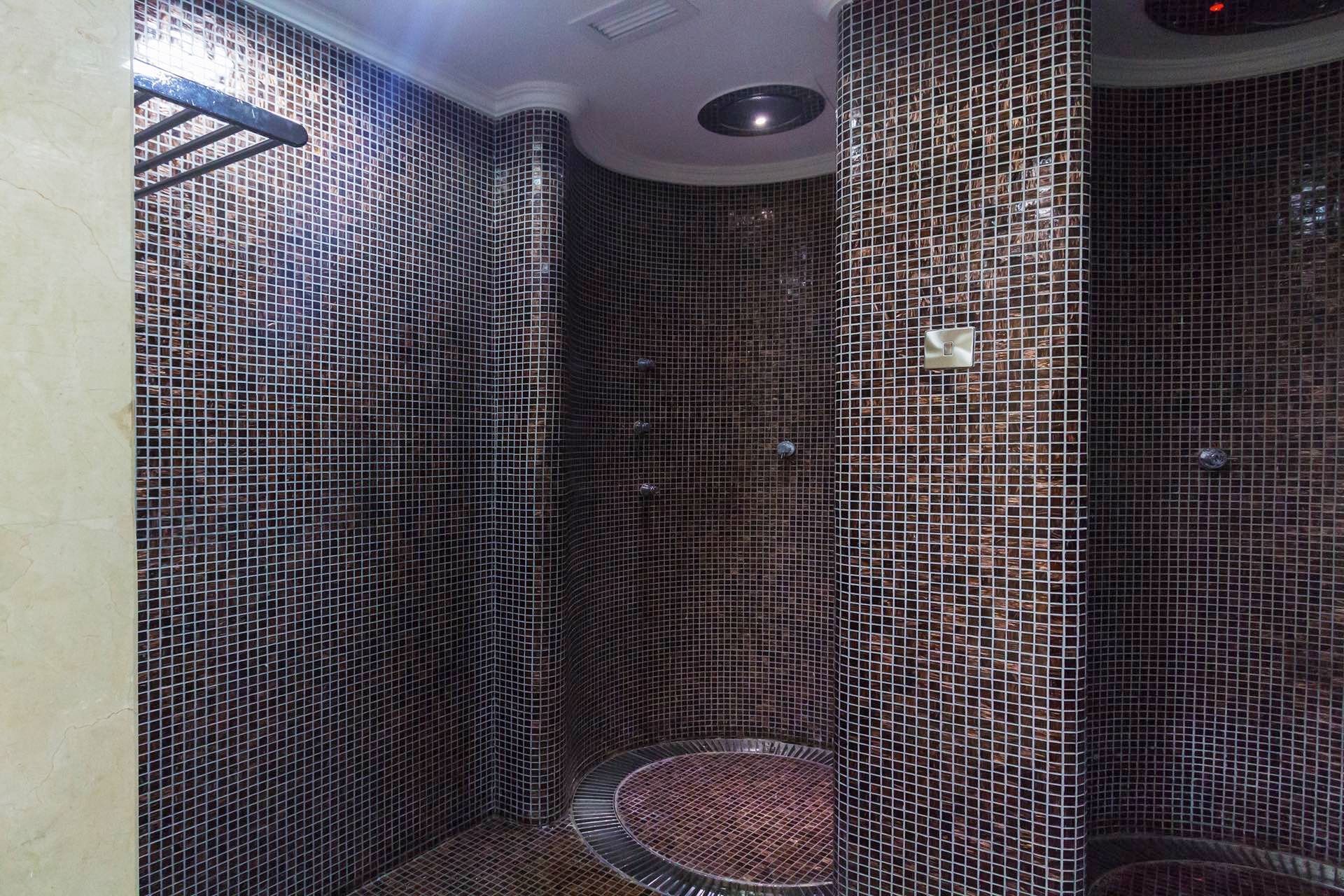 Spacious shower with a tiled wall in Spa at Warwick Doha