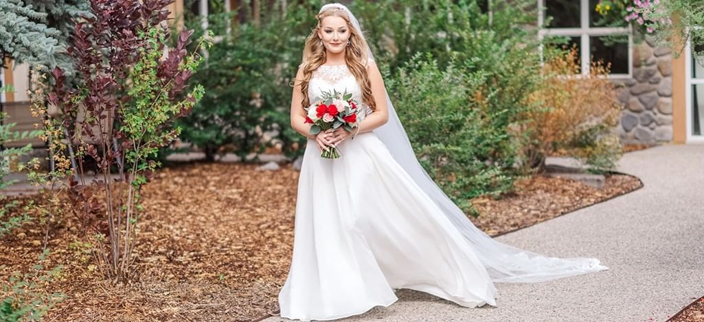 A bride comes out for the first look with the groom at a wedding venue in Canmore.