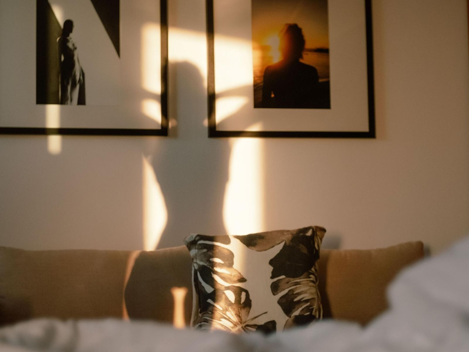 Lady's shadow on a wall with pictures featuring romantic experiences at Janeiro Hotel