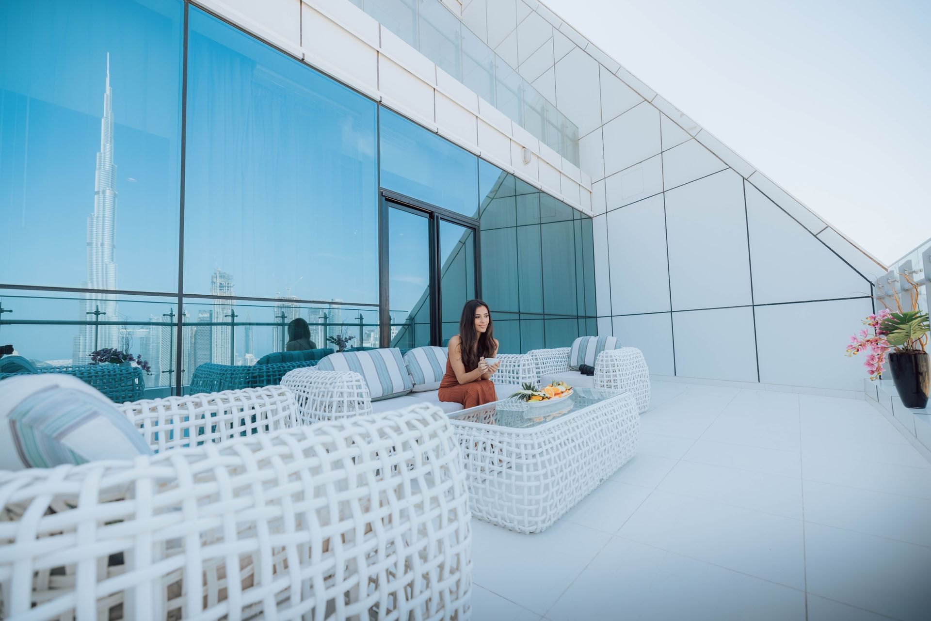 Woman enjoying breakfast at DAMAC Maison Distinction, featuring fine dining in Dubai