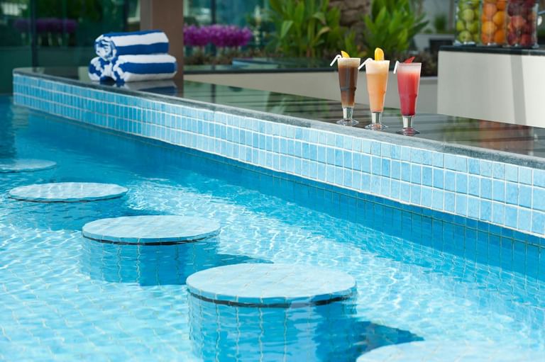 Drinks served on the outdoor pool edge at DAMAC Maison Canal Views