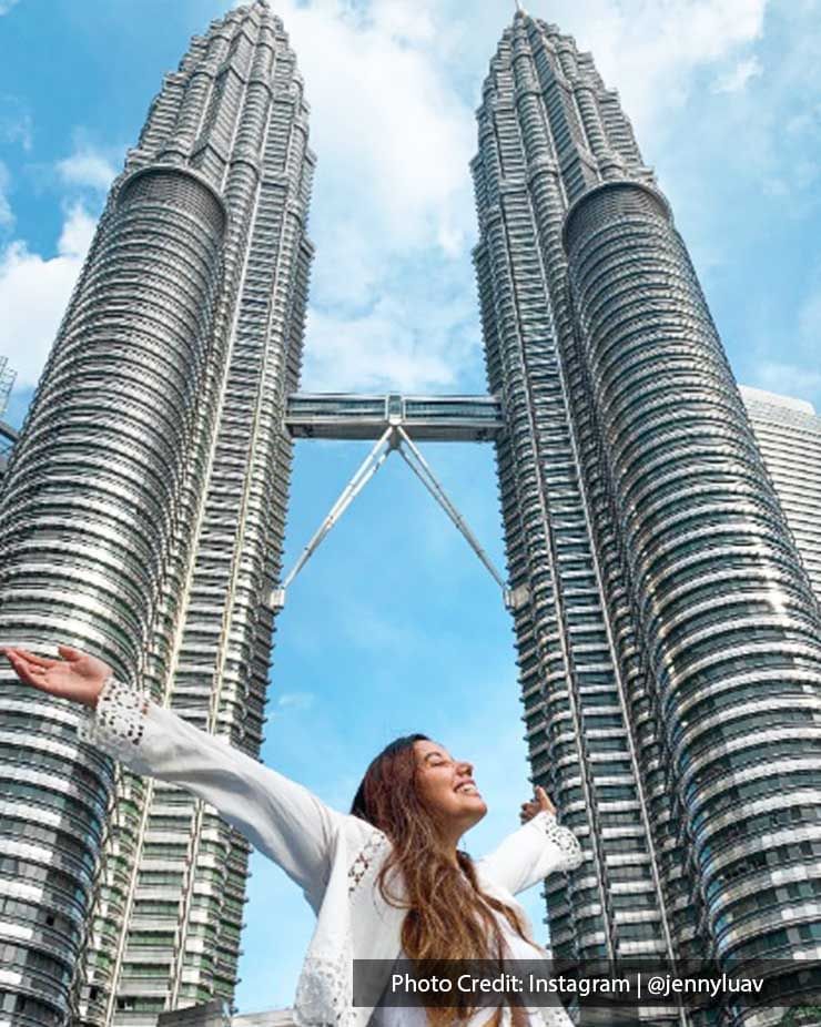 Girl posing under The Petronas Twin Towers, a local attraction near Imperial Lexis Kuala Lumpur