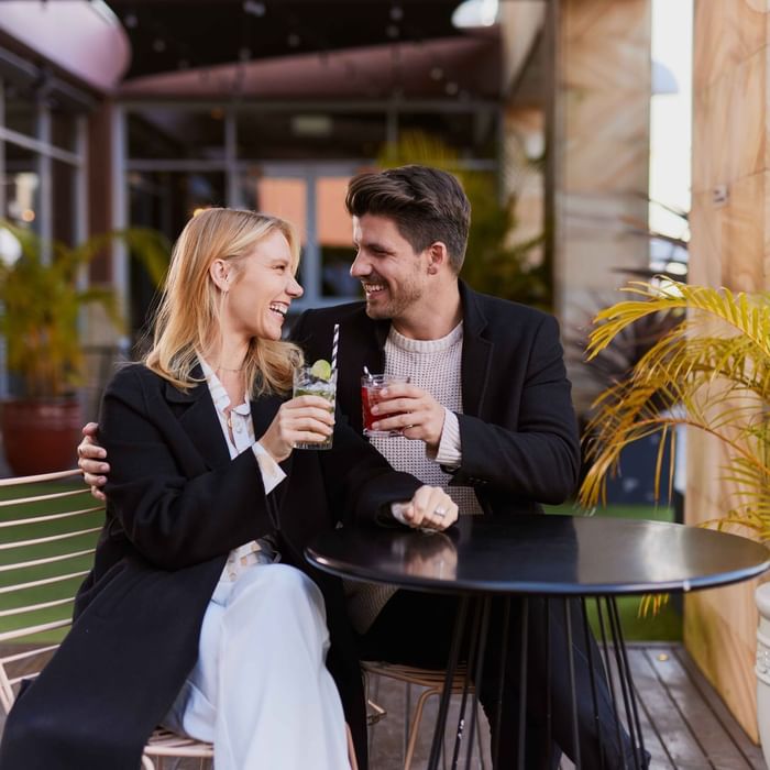Couple enjoying sunset drinks on ibis bar deck