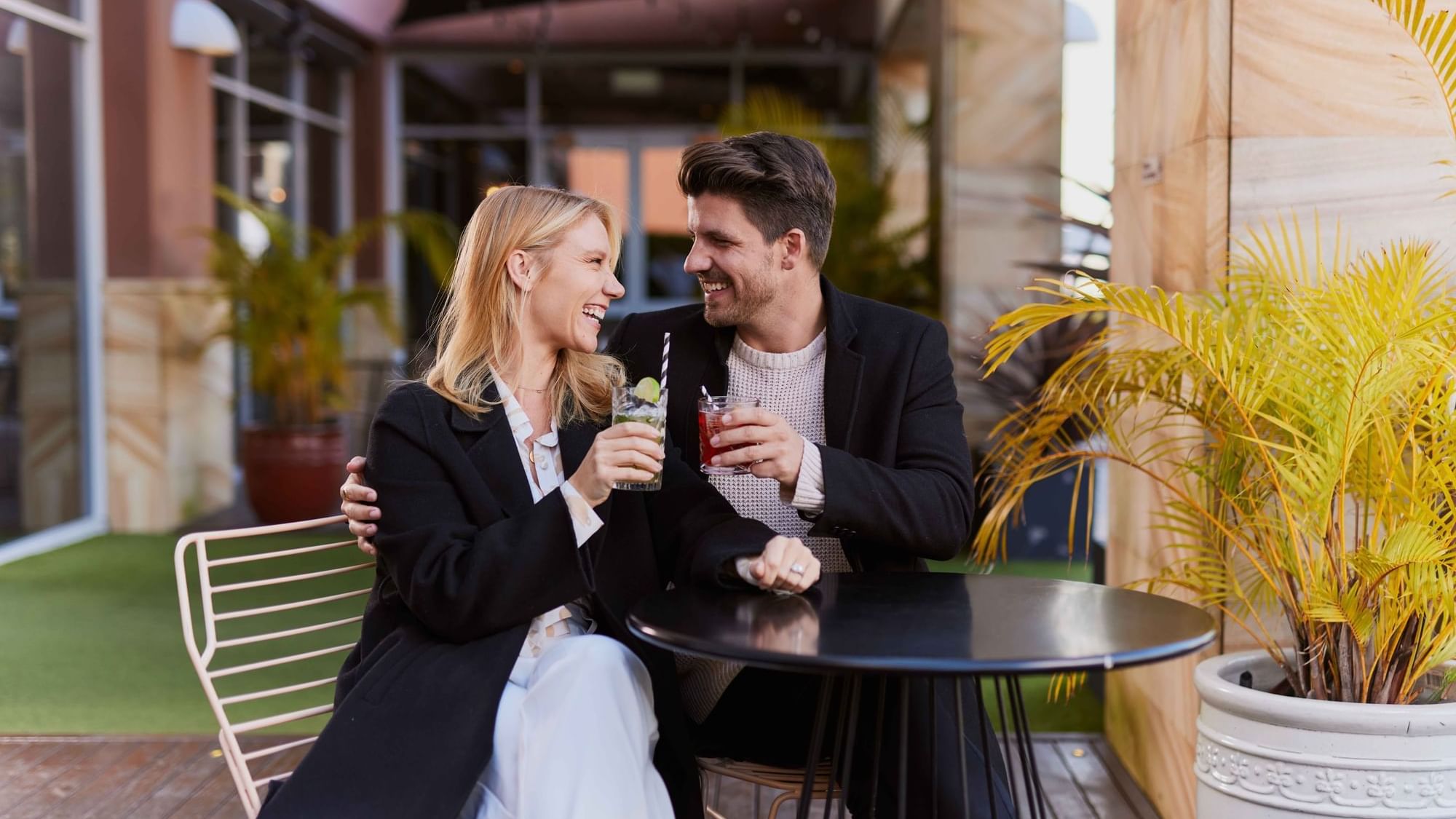 Couple enjoying sunset drinks on ibis bar deck