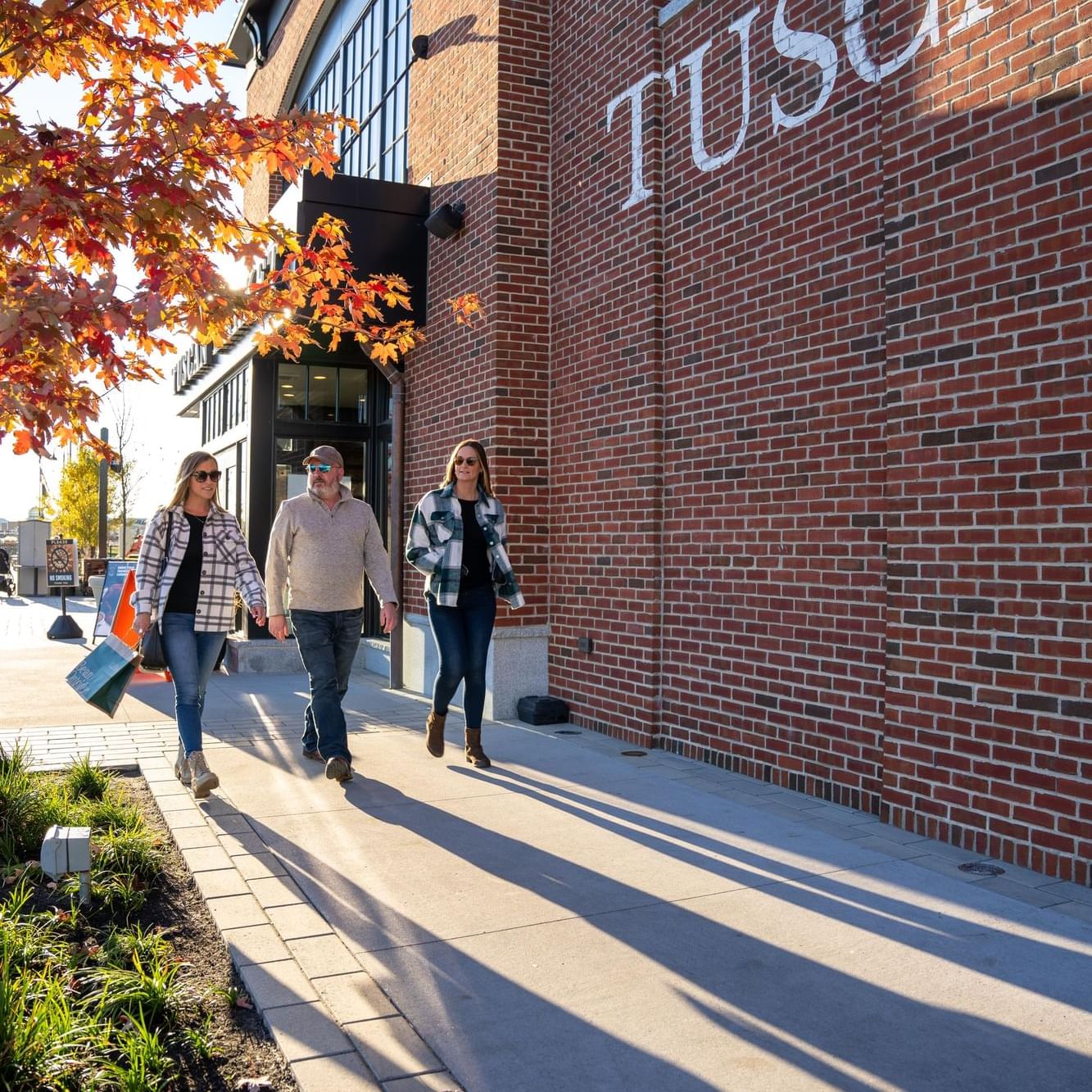 People walking on a street in Tuscan Village near The Artisan Hotel at Tuscan Village