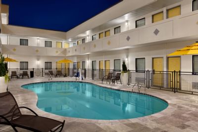 The indoor pool and the lounge at Hotel Bo at nighttime