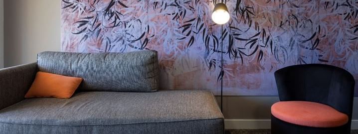 A wall picture behind the sofa in a room at Novotel Barossa