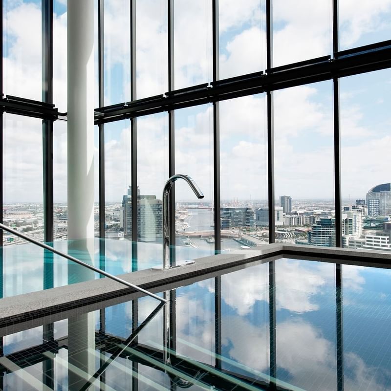 Indoor pool with a city view at Crown Metropol Melbourne