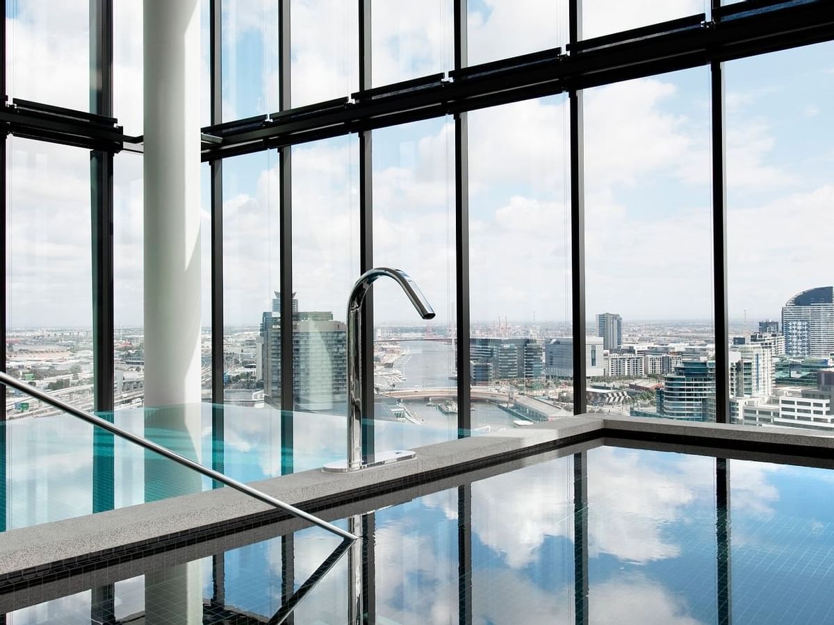 Indoor pool with a city view at Crown Metropol Melbourne