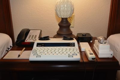 Nightstand with Appliances in Hotel Room at Rosen Inn International