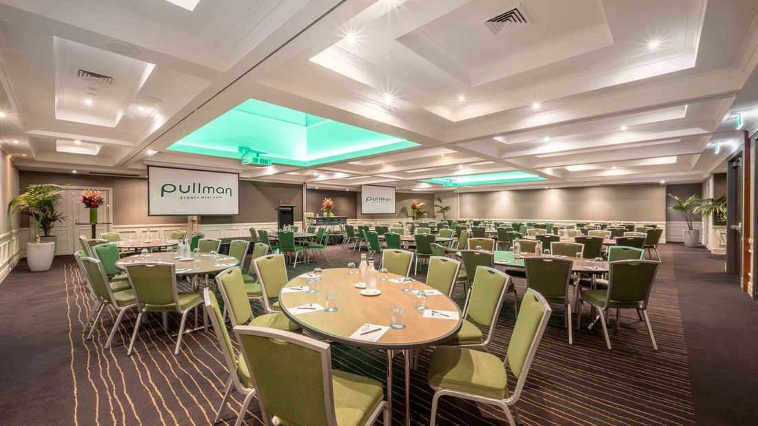 Banquet set-up with projector screens in Ibis Room at Pullman Sydney Hyde Park