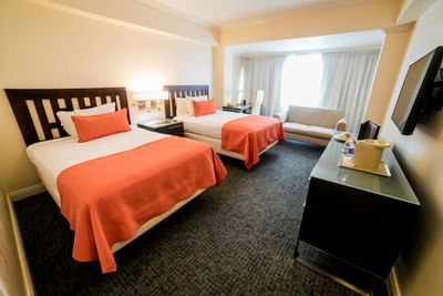 An interior of a room with two beds at Jamaica Pegasus Hotel