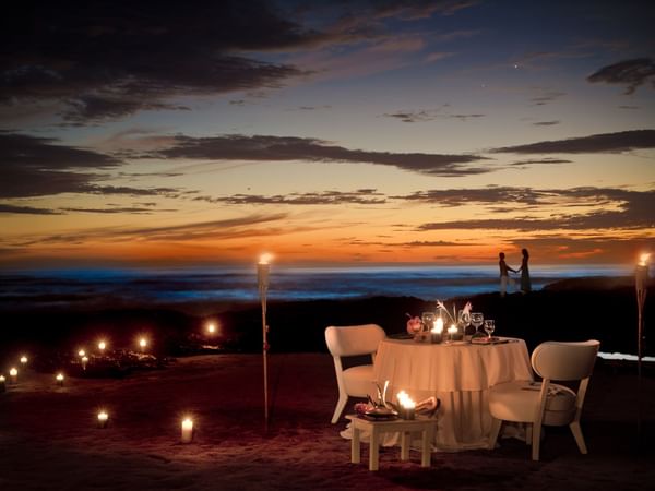 Romantic dinner setup by the beach at Cala Luna Boutique Hotel