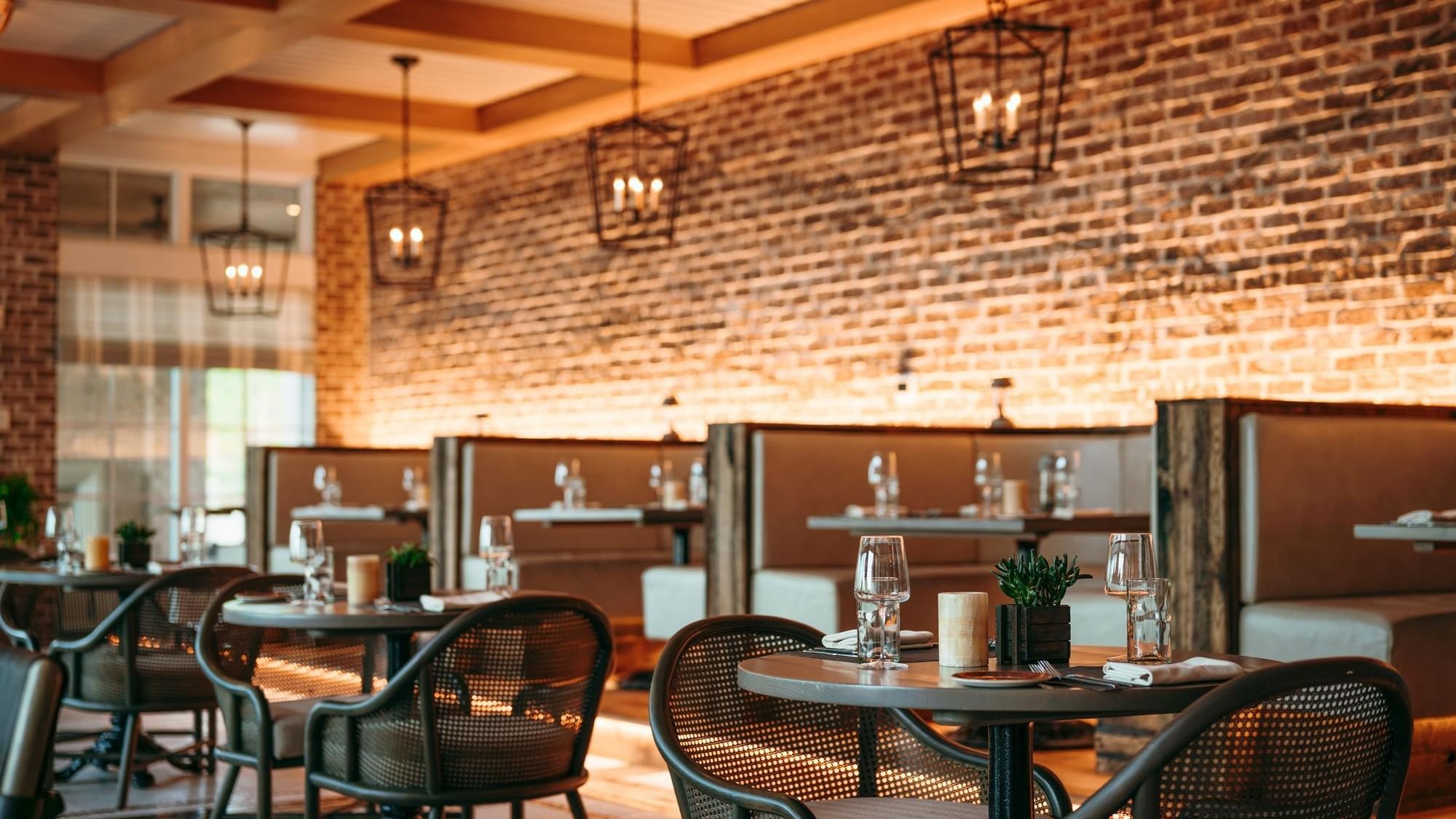 Tables with chairs and wine glasses in ANR restaurant Inlet Beach.