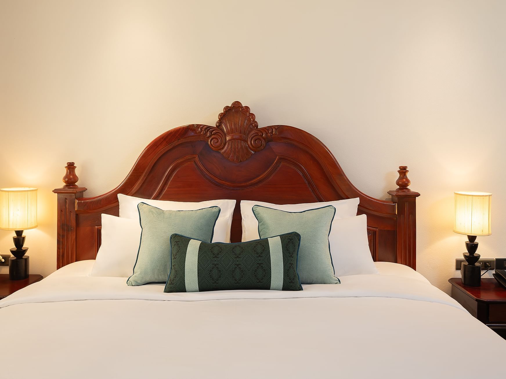 Bed with nightstand in Heritage Villa at U Luang Prabang