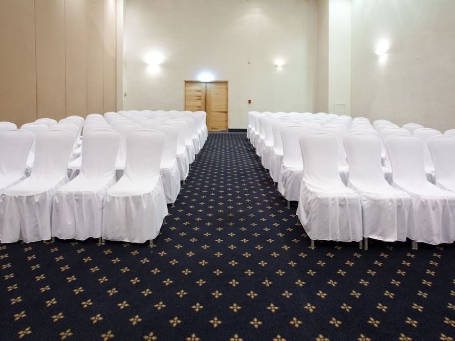 Chairs with white covers in a seminar at Gamma Hotels