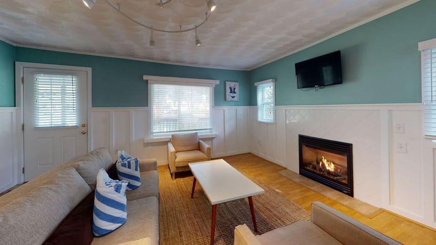 TV lounge with fireplace by the window in Nick Cottage at Breezeway Boutique Hotel