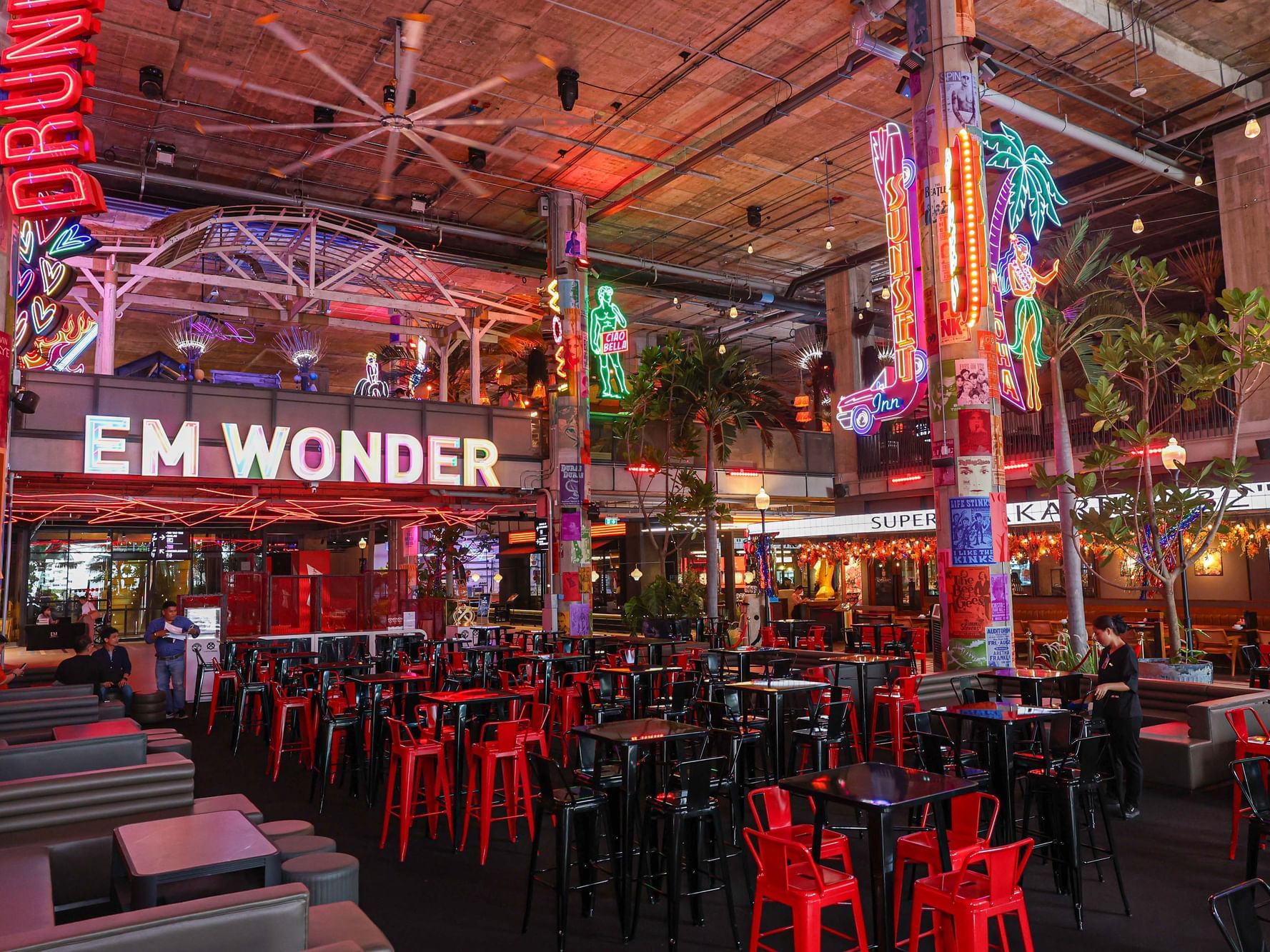 A restaurant interior featuring red and black chairs and tables, creating a vibrant and modern dining atmosphere.