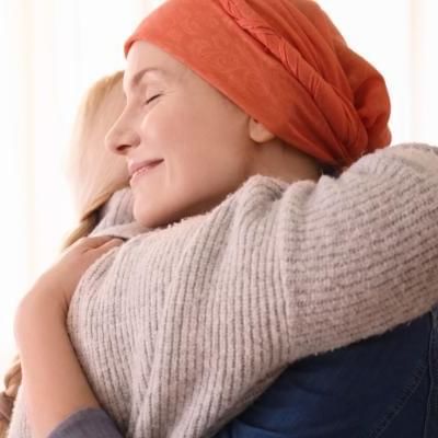 women hugging her friend that is batteling cancer