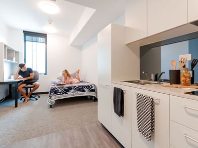 Modern studio apartment with kitchenette, study desk, and single bed at UniLodge Park Central