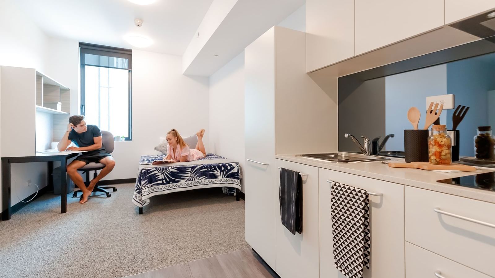 Modern studio apartment with kitchenette, study desk, and single bed at UniLodge Park Central