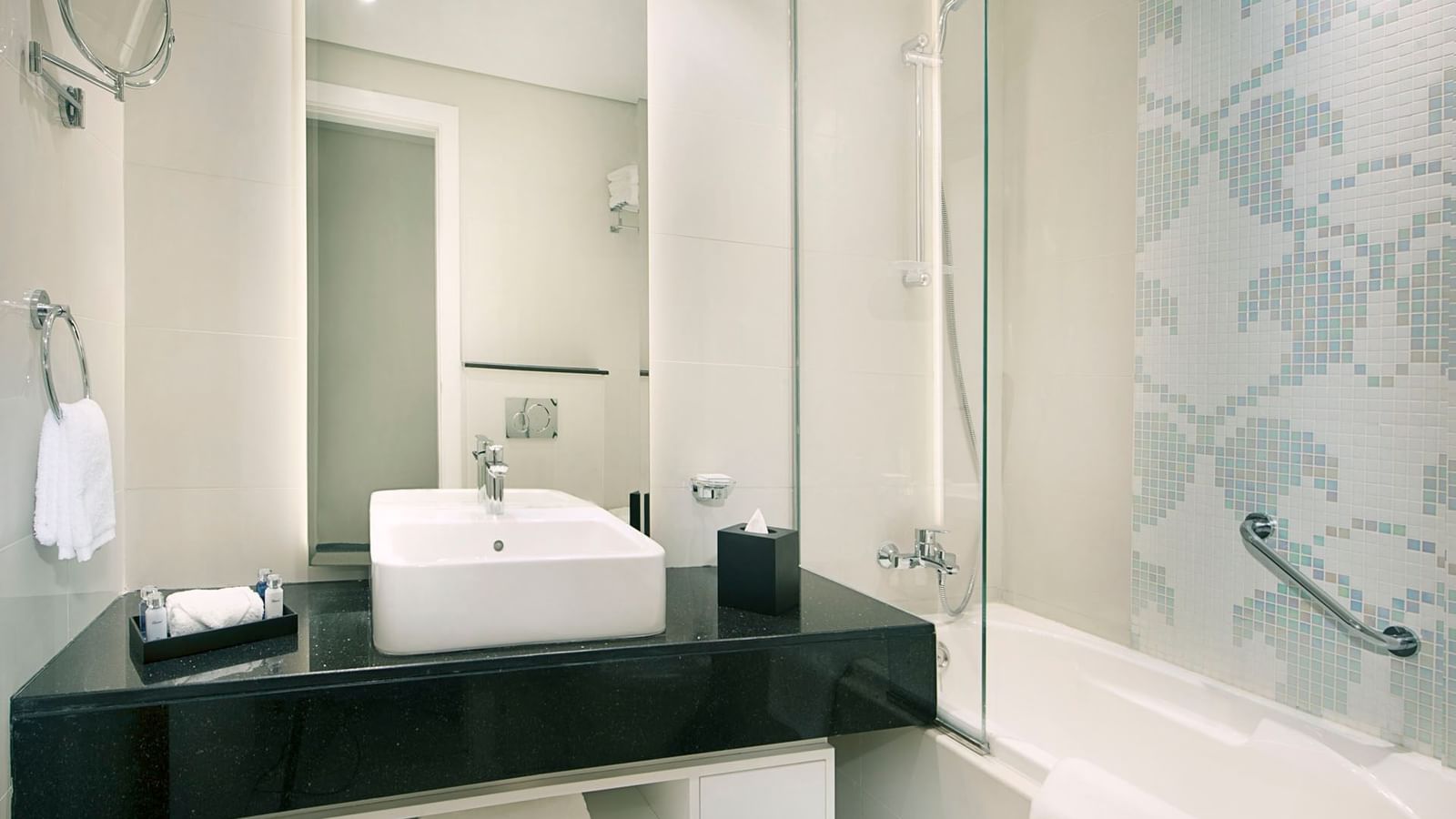 Bathroom amenities with a vanity mirror in One Bedroom Suite at DAMAC Maison Canal Views