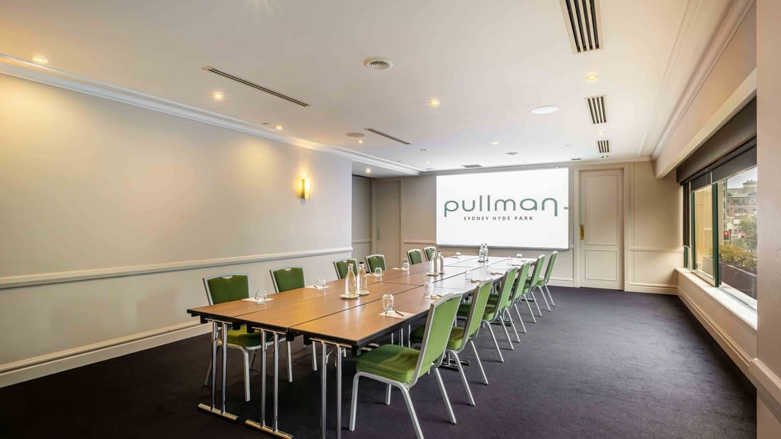 Boardroom set-up with projector screen in Parkview Room at Pullman Sydney Hyde Park