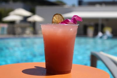 Closeup of a cocktail on a poolside table at Anaheim Hotel