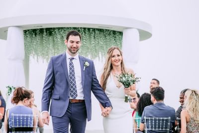 Wedded couple walking down the aisle, Morgan Resort Spa Village
