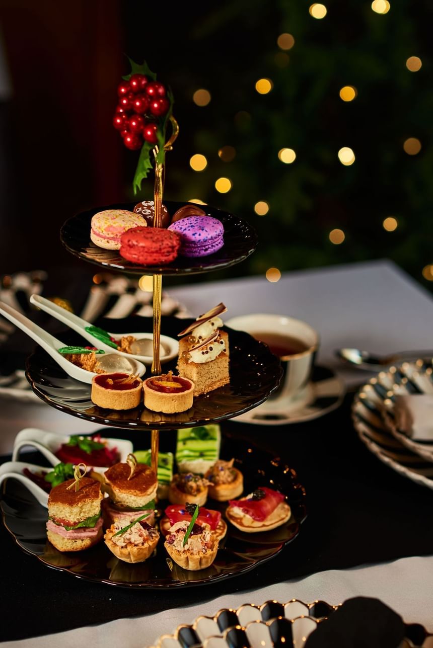 Three-tier tray with assorted desserts and maccarons at Hotel Arista
