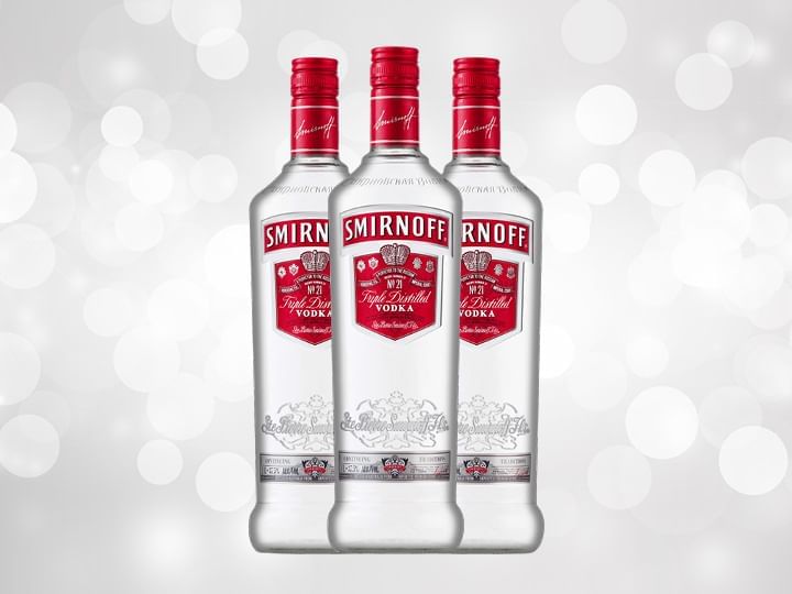 Three Smirnoff Vodka Bottles against a silver background