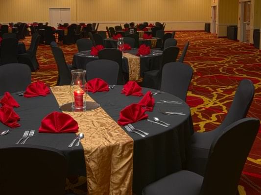 Banquet tables in red & black at a party in MCM Hotel Lubbock