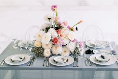 Table set up with floral decor and fine dinnerware at Polonia Palace Hotel