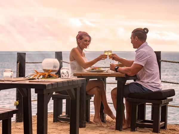 Couple enjoying cocktails with a sea view at The Warwick Fiji 