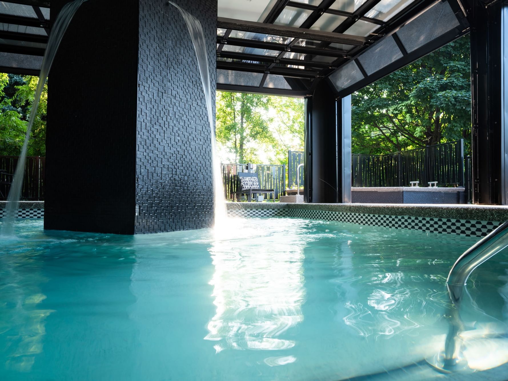 Spillways in the open heated pool overlooking the garden at The Earl