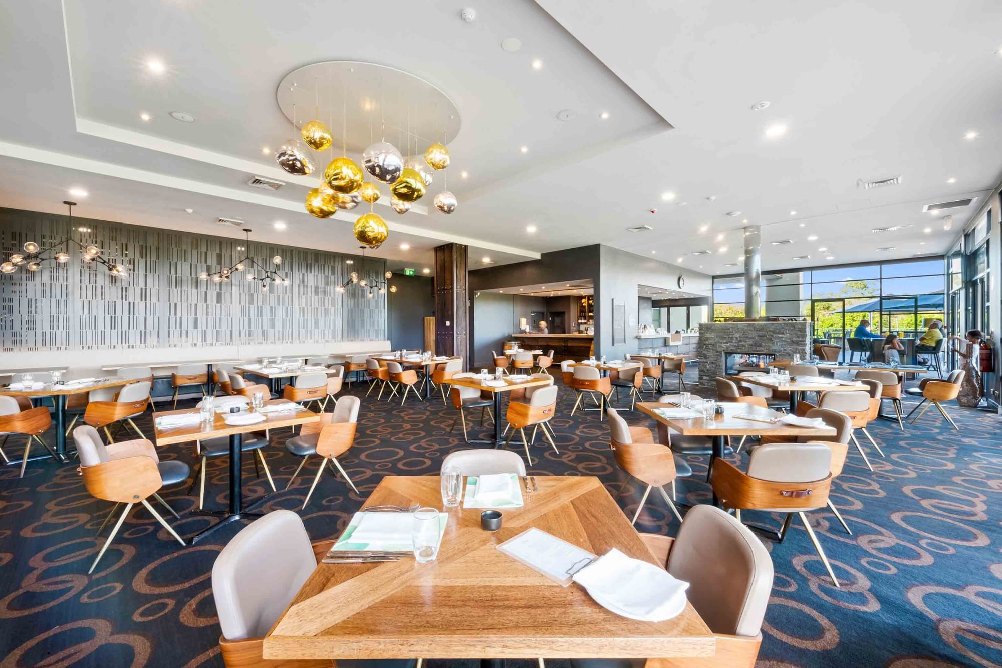 Karinyas Restaurant and Wine Bar dining area with lighting feature at Mercure Kooindah Waters