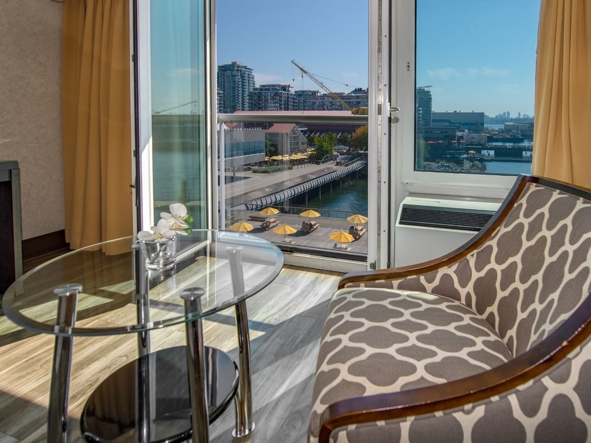 Coast Premium Queen room with chair, glass table, and a city view at Coast Lonsdale Quay Hotel