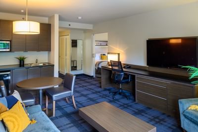 Suite with a dining table by an office desk counter at Rodd Miramichi River, an apartment hotel in Miramichi, NB