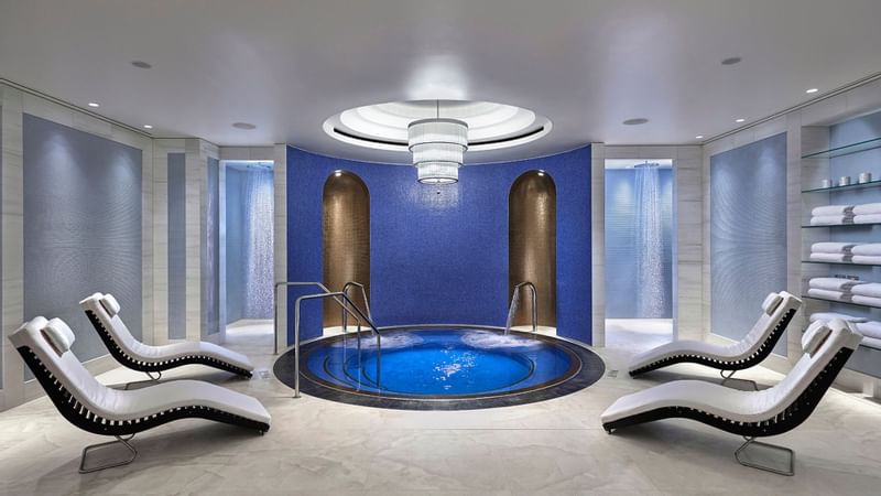 Indoor pool with lounges at Crown Hotels Spa
